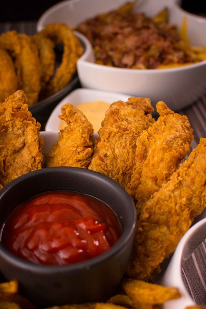 Crafting Captivating Headlines: Your awesome post title goes here Close-up of crispy fried chicken served with ketchup and mustard sauce.